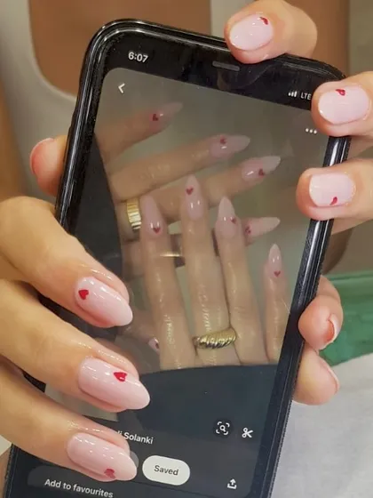 You dream it, I create it. This client brought in an inspiration photo of delicate heart nail art on a sheer pink base, and I brought it to life. I love collaborating with you to create your perfect custom nail design.
