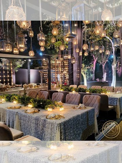 An enchanting evening setup with tables illuminated by candlelight and dozens of hanging lanterns. We create magical dining experiences.