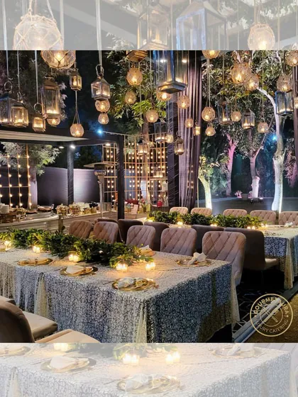 An enchanting evening setup with tables illuminated by candlelight and dozens of hanging lanterns. We create magical dining experiences.