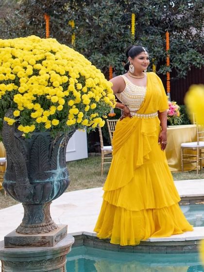 Basking in the glow of Haldi hues. For this ceremony, we styled the bride in a flowing, turmeric-yellow drape saree that was both elegant and easy to wear, perfect for a day of celebration.