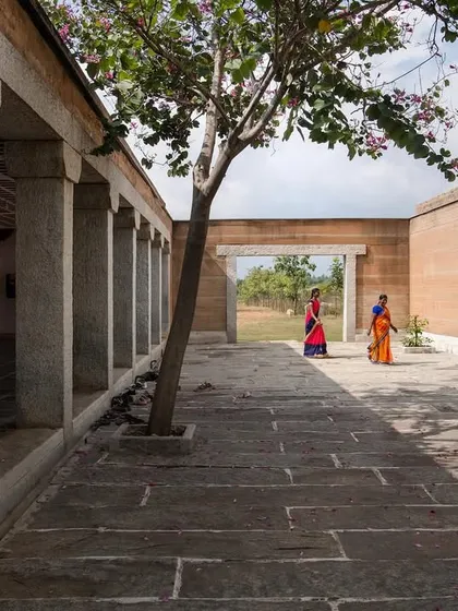 The stone-pillared courtyard at the H.N. Science Center, a space that is open to the elements and allows for natural light and ventilation. The design is inspired by traditional Indian courtyards.