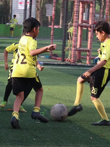 A duel for the ball shows the competitive but fair nature of our training games.