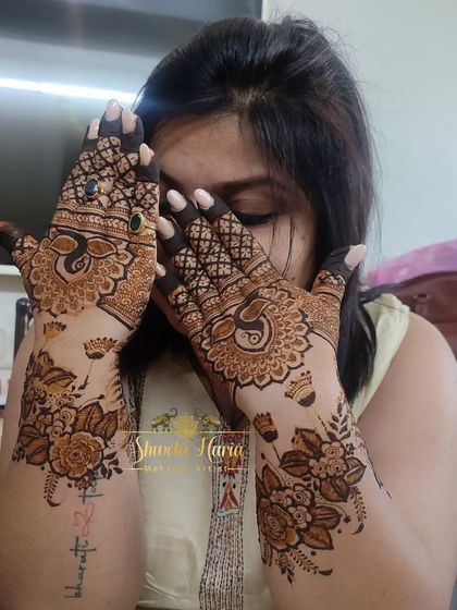 A fancy back-hand design with a mix of styles, including floral arrangements, peacock mandalas, and gemstone-like details.