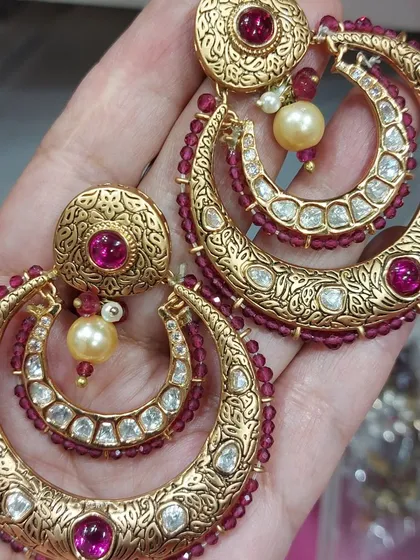 A beautiful pair of earrings can complete any outfit. These gold-plated chandbali earrings with ruby-coloured stones and pearl drops are a great example of the statement pieces you can rent from my collection.