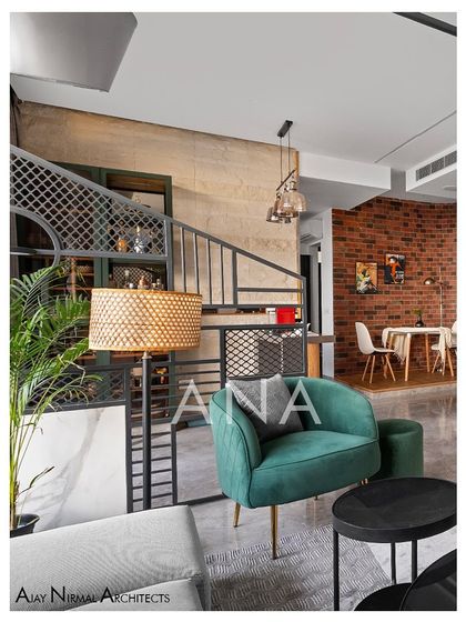 A view from the sitting area towards the breakfast nook in Apartment 704. The design uses different materials and textures, like the raw brick wall and stone-clad bar area, to define zones within the open-plan space.