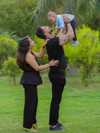 The joy on a child's face when they are lifted high in the air is priceless. Outdoor sessions give us the space to capture these dynamic and energetic family interactions.