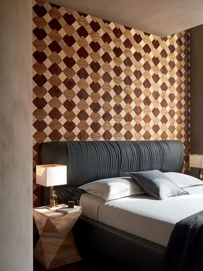 A masterpiece of craftsmanship, this wood marquetry wallpaper creates a dynamic checkerboard pattern behind a bed. The design transforms wood into a fluid interplay of elegance and motion.