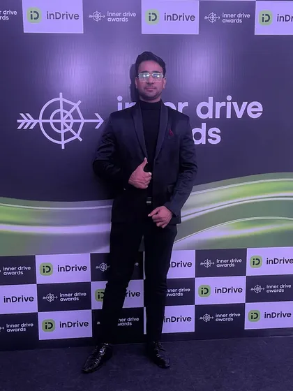 At the inDrive "Inner Drive Awards" photo wall. I enjoy being part of the celebration with the employees and management.