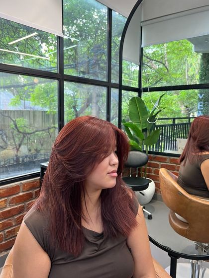 A side view of the butterfly cut, showing how the layers frame the face and add beautiful shape to the hair.