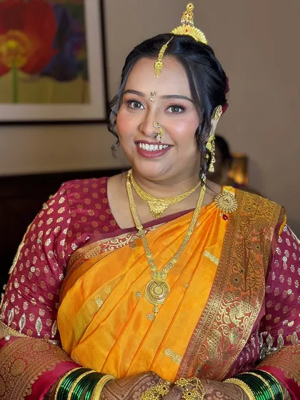 A happy bride glowing in her traditional wedding attire, with makeup that enhances her natural features.