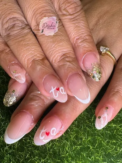 Karwachauth special nails. This elegant design features French tips with the initials 'T' and 'A' and tiny hearts, perfect for the occasion.