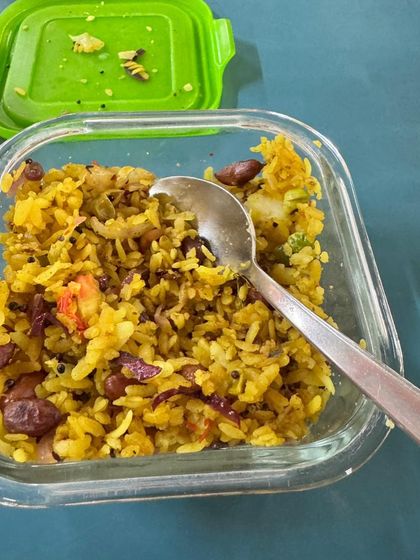 A lunchbox filled with vegetable poha. This is a convenient and healthy meal for a client to take to work.