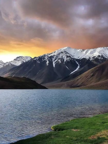 A dramatic sunset over Chandratal Lake. Our river bank camping experience allows you to witness these magical moments.