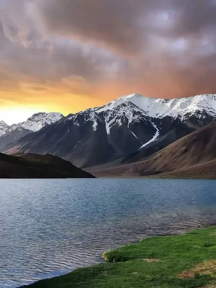 A dramatic sunset over Chandratal Lake. Our river bank camping experience allows you to witness these magical moments.