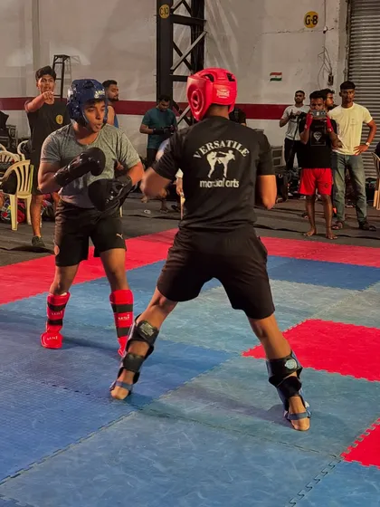 A close-range exchange during a kickboxing match. We train our students to be comfortable and effective in all situations.