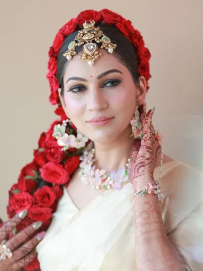 A close-up of the bride's stunning floral braid and makeup. The look is a perfect blend of tradition and modern creativity.