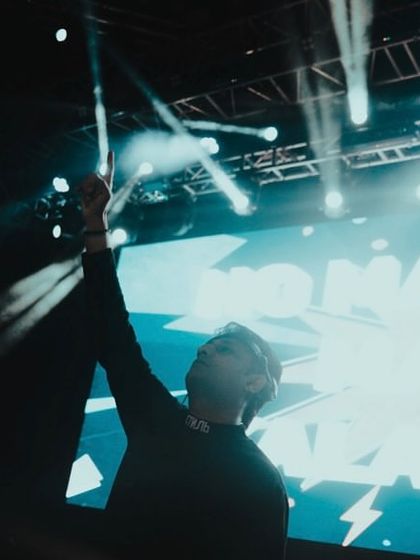 Pointing to the sky with the crowd at JIMS Delhi. It's all about shared energy and creating a memorable night.