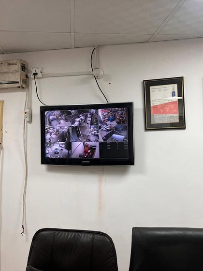 A wall-mounted monitor in a manager's office, providing a live view of the facility. This allows for real-time supervision of operations.