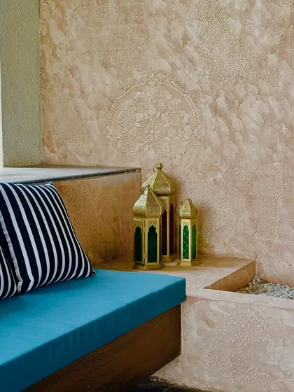 Decorative Moroccan-style lanterns add a touch of exotic charm and provide soft, ambient lighting in the evening.