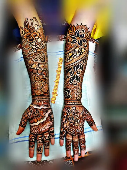 This full-arm design showcases a beautiful flow of different patterns. One arm features a spiraling floral vine, while the other has more structured, symmetrical motifs, demonstrating artistic versatility.