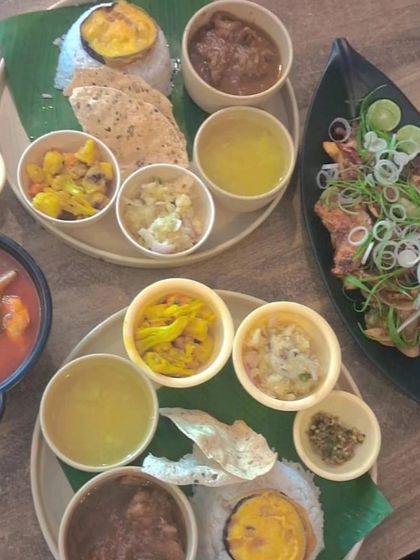 A feast for friends and family. Here you can see our different thalis served alongside other starters, showing the variety of a full Northeast Indian meal.