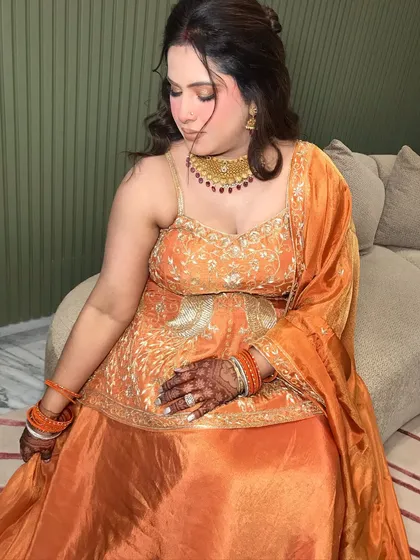 A serene portrait, her hands showing her mehndi and rings.