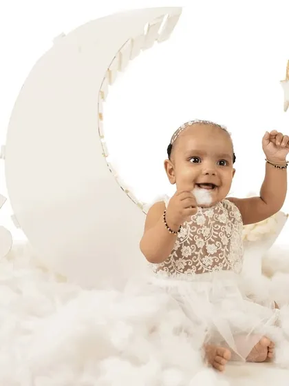 A playful moment on the moon. Sitter sessions are perfect for capturing your baby's personality as they start to interact and play.