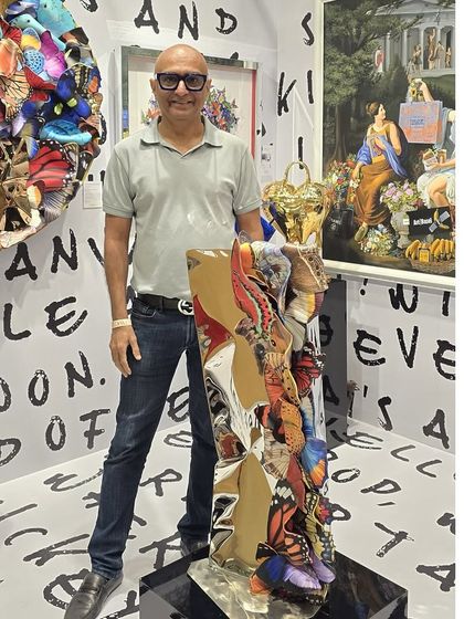 Posing with another freestanding butterfly sculpture at the exhibition.