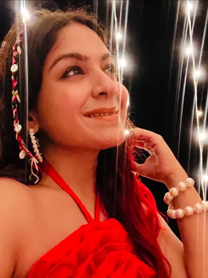 Another picture from the Goa trip, showing off my red halter dress and pearl accessories against a backdrop of fairy lights. It was a perfect evening look.