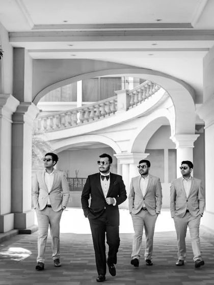 The groom and his squad. This black and white shot of Roshan and his groomsmen walking through a classic corridor has a cool, cinematic feel, like a scene from a stylish movie.