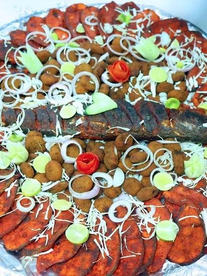 A feast for the eyes and the palate. This platter showcases a variety of our seafood specialities, including whole fried fish and prawn cutlets, all prepared fresh for the event.