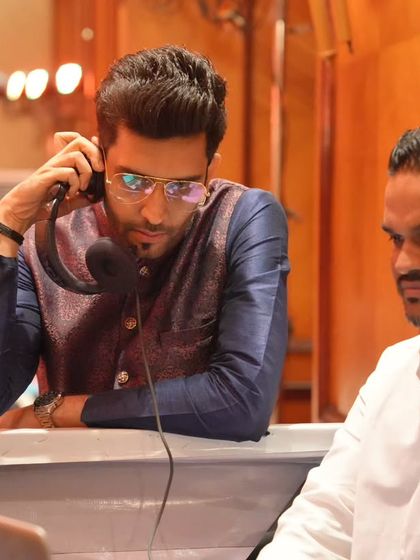 Behind the scenes with the DJ. Perfect coordination is key to a seamless show, and I always do a final check on cues and music before going live.