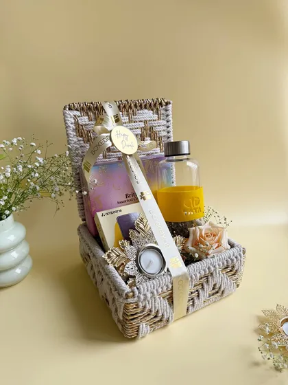 A different angle of the TATA branded Diwali hamper, showing the beautiful woven basket and the curated items inside, including a power bank and a festive diya.