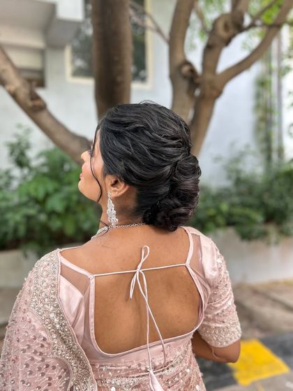 A beautiful profile of the textured low bun, a perfect hairstyle for a reception or engagement party.