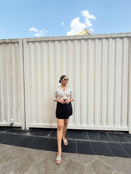 Another angle of the satin shirt and skort combination. The clean lines and classic color palette make it a timeless and versatile outfit.