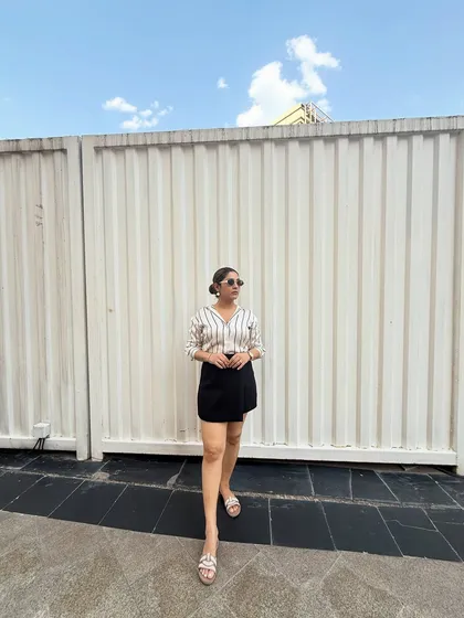 The clean lines of this outfit make it a great example of timeless style. A simple, well-fitting shirt and skirt can be the foundation for many different looks with the change of accessories.