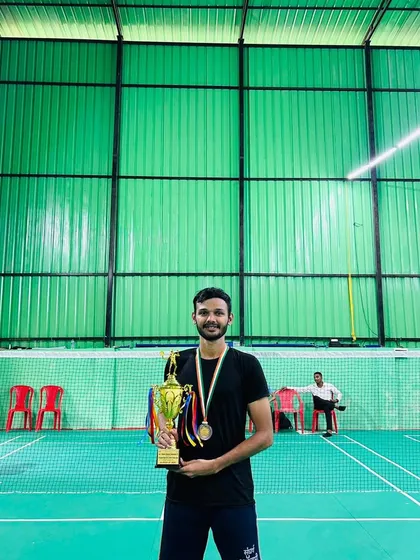 Our player holding his runner-up trophy from the Inter-Collegiate Badminton Tournament (Mumbai University), representing Birla College in the team event.