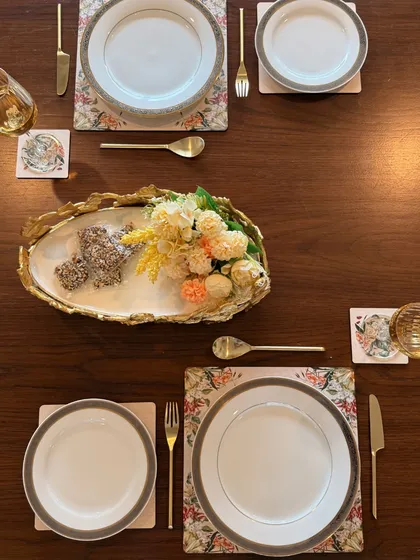 An overhead view of our elegant table for two, showcasing how our serving platter, placemats, and coasters come together. Each piece is designed to complement the others for a cohesive tablescape.