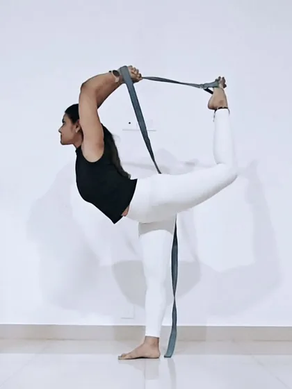 Props are your friends, not a sign of weakness. Here, I'm using a yoga strap to gently deepen the stretch in Natarajasana, or Dancer's Pose. This allows for a safer, more effective heart and shoulder opener, regardless of your current flexibility.