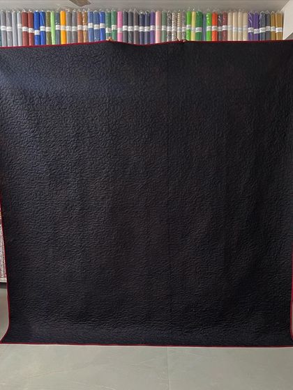 The simple black backing allows the intricate quilting pattern to stand out.