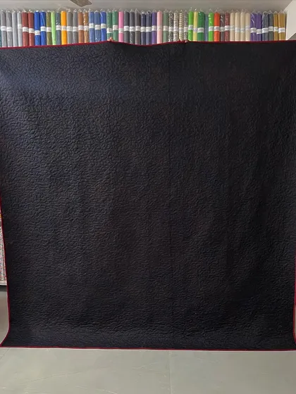 The simple black backing allows the intricate quilting pattern to stand out.