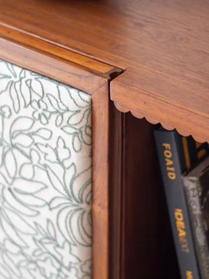 The Aamira storage unit is a piece with details galore. It can function as a bookcase, crockery unit, or bar, and features finger grooves, stained glass, and brass inserts, making it a statement piece for any living or dining area.