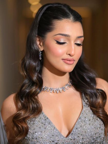 A close-up of the luminous look with eyes closed, highlighting the perfect blend of shimmer on the eyelids and the flawless skin finish.