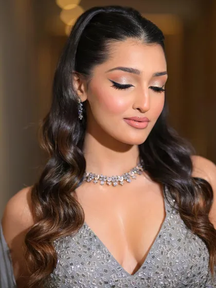 A close-up of the luminous look with eyes closed, highlighting the perfect blend of shimmer on the eyelids and the flawless skin finish.