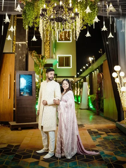 Another angle of the couple at their reception, showing the grand entrance decor.