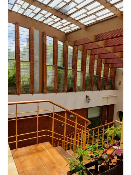 A staircase is a perfect place to play with light. Here, a large window wall and a skylight illuminate the wooden stairs and bright yellow railing, making the journey between floors a bright and uplifting experience.