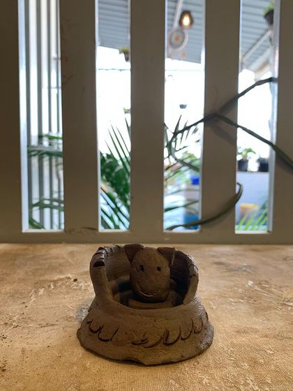 A tiny turtle peeking out of its shell. This small, hand-built sculpture is full of character.