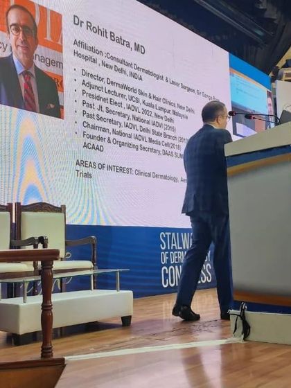 Walking onto the stage to begin my lecture. It is a privilege to share my knowledge on the safe and effective protocols for laser hair reduction with my peers in the dermatology community.