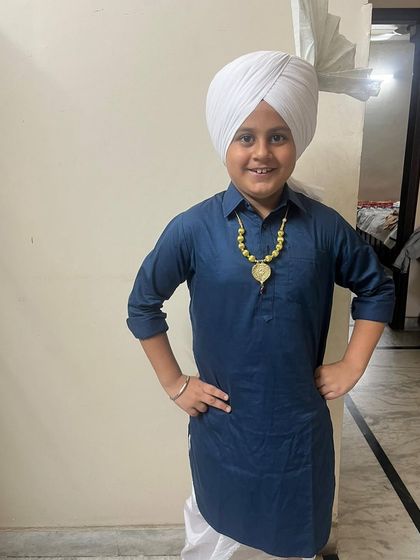One of our proud students dressed in a traditional Punjabi kurta pajama and turban, ready for his school dance competition. We help our students with costumes and presentation too.