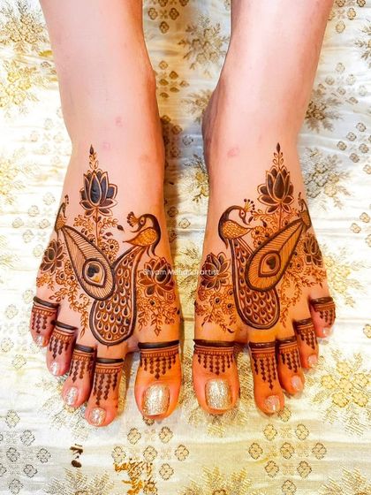 A beautiful foot design featuring stylized peacock motifs, perfect for a bride who loves traditional art.